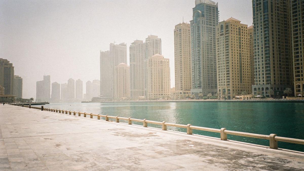 Dubai Marina waterfront at midday during the June heat window