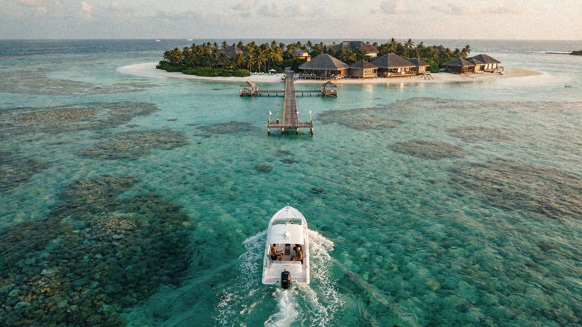 Speedboat crossing to a North Male atoll jetty in morning light
